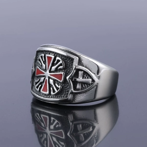 Macro shot of silver stainless steel ring with red enamel cross and shield relief