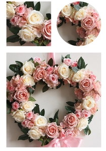 Detailed close-up of heart-shaped artificial rose wreath with silk bow for weddings