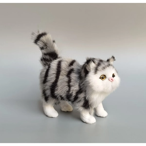 Detailed view of lifelike grey tabby cat figurine with realistic fur and yellow glass eyes
