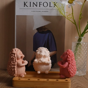 Three cute 3D hedgehog silicone molds and finished scented candles with detailed texture