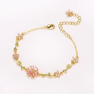Pink sakura flower charm bracelet in gold finish with crystals and adjustable chain