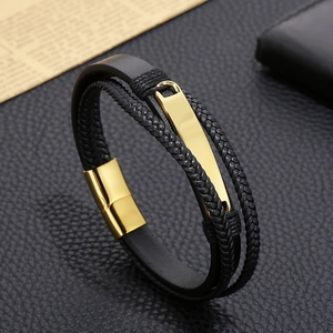 Close-up of multilayer black leather braid with polished gold titanium steel clasp