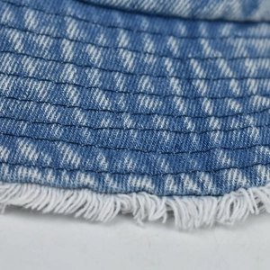 Detail of blue washed denim bucket hat brim with distressed fringe and parallel stitching