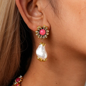 Detail macro view of retro baroque pearl earrings with golden flower and sparkling diamonds