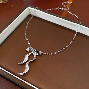 Détail d'un collier en argent avec pendentif nœud dans son coffret cadeau bijoux