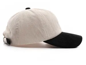 Side view of two-tone corduroy baseball cap with cream crown and black brim detail