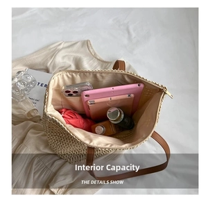 Detailed interior view of a large straw tote bag showing high storage capacity and lining