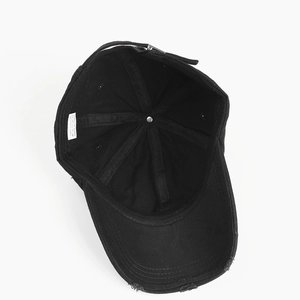 Detailed interior view of a black washed cotton baseball cap with 100% cotton label