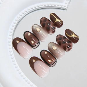 Golden brown cat-eye press-on nails with leopard patterns and sparkling rhinestones