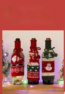 Close-up of knitted Christmas wine bottle covers with Santa, reindeer and snowman patterns