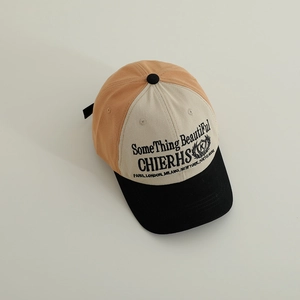 Detail view of cotton color-block baseball cap with embroidered lettering and short brim