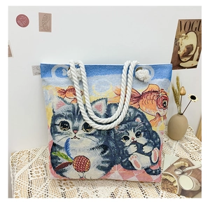 Detailed texture of jacquard fabric tote bag with cat and goldfish pattern design
