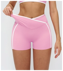 Détail du short de yoga rose avec taille en V croisée et liserés contrastés blancs sport