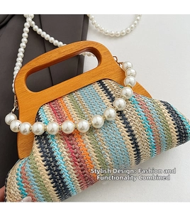 Detail of colorful woven straw bag with dark wooden handle and pearl decorative strap
