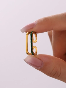 Detail of a vintage double-layer gold ring featuring sparkling green zircon gemstones