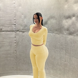 Detail view of yellow V-neck loungewear set featuring delicate lace trim on the neckline