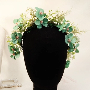 Detail of mint green floral headband with pink accents on a studio model