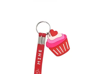 Detail of red silicone cupcake keychain with metal ring and white Mine text strap