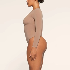 Side view of a slim-fit khaki long sleeve bodysuit featuring high-cut leg and stretchy fabric