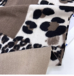 Macro shot of thick leopard print scarf showing soft texture and premium knit detail