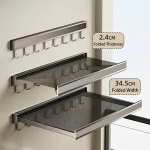 Space-saving folding clothes rack in matte grey aluminum for balcony wall mounting