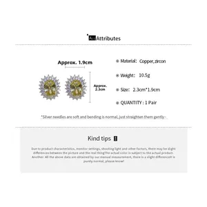 Detailed view of yellow zircon oval stud earrings with silver needles and gold-plated copper