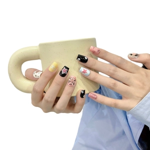 Handmade star and flower press-on nails with colorful pastel designs on a matte finish