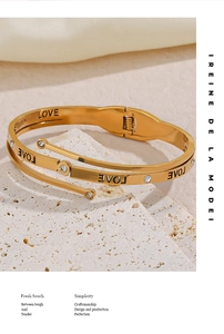 Detailed macro view of the gold-plated LOVE bangle with sparkling cubic zirconia stones