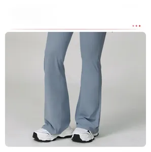 Detail shot of flare-leg yoga pants in dusty blue featuring leg-elongating cut and drape