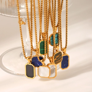 Detail of square gold pendants with colorful inlays like malachite and tiger eye