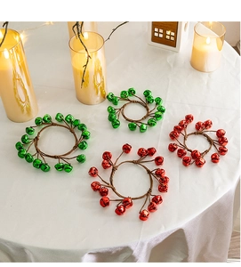 Close-up of red and green metal bell napkin rings for Christmas table decoration