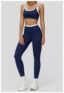Detail of high-waist yoga pants with white contrast waistband and navy stretch fabric