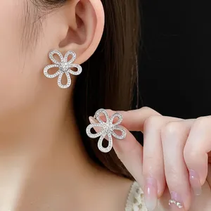 Elegant silver openwork flower stud earrings with sparkling cubic zirconia crystals