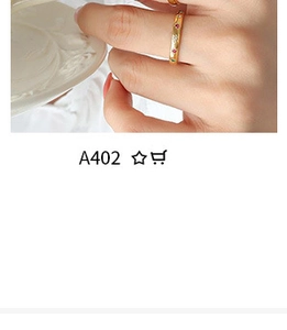 Close-up of gold ring with colorful gemstones on finger showing elegant jewelry detail