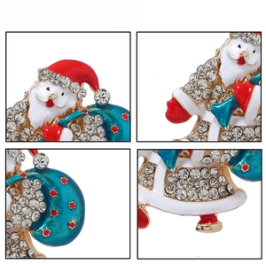 Macro detail of Santa Claus brooch with sparkling rhinestones and enamel finish