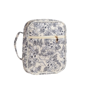 Quilted floral prayer book cover with handle and gold zipper pocket in beige and navy