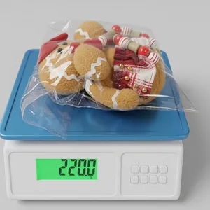 Gingerbread man gnome plush toy on an electronic scale showing 220g weight detail