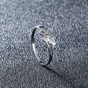 Detailed side view of silver stainless steel butterfly ring with white inlaid wings