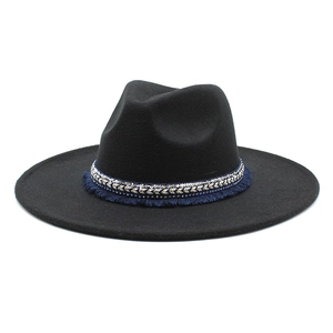 Detail of black fedora hat featuring ethnic blue fringe and gold sequined decorative band