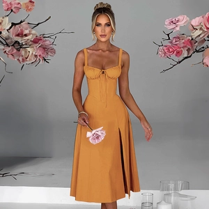 Detail of warm orange strapless midi dress featuring front drawstring and side slit
