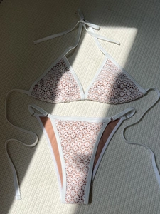 White hollow lace bikini set with halter top and high cut bottoms in nude lining