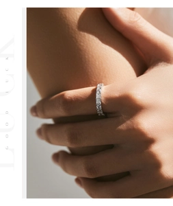 Close-up of luxury S925 silver eternity ring with square-cut sparkling crystals on finger