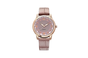 Detail of rose gold quartz watch with dusty pink dial and crocodile pattern leather strap