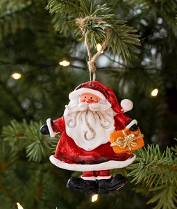 Detail of a vintage Santa Claus resin hanging ornament with rustic jute rope on Christmas tree
