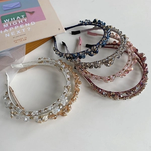 Close-up of assorted crystal beaded headbands in multiple colors on a clean background