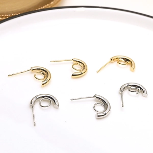 Detailed view of 18k gold and silver plated C-shape earring hooks with hanging loops