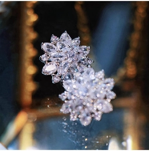 Macro view of snowflake stud earrings with sparkling marquise-cut cubic zirconia crystals