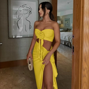 Detail of yellow two-piece set with tube top, 3D flower and high slit skirt