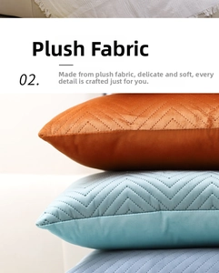 Detail of velvet pillow covers with embossed chevron pattern in blue and orange