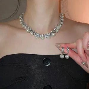 Elegant diamond-encrusted geometric pearl necklace and drop earring set for women